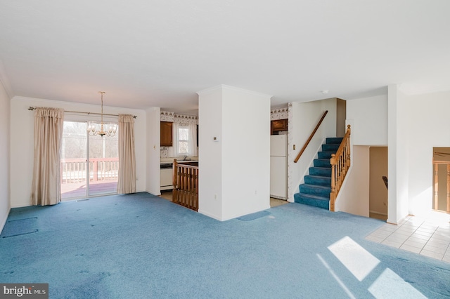 unfurnished living room featuring a notable chandelier, stairway, crown molding, light tile patterned floors, and light colored carpet