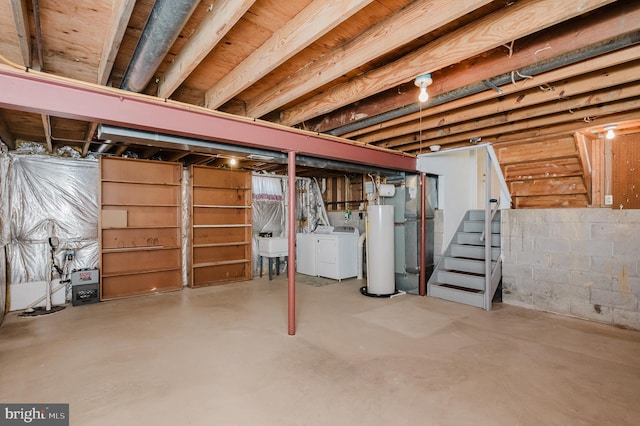 unfinished basement featuring washer and dryer, a sink, water heater, stairway, and concrete block wall