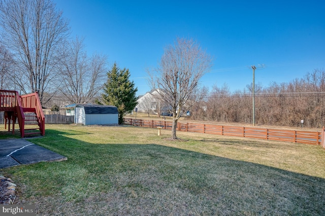 view of yard featuring a fenced backyard, a storage shed, and an outdoor structure