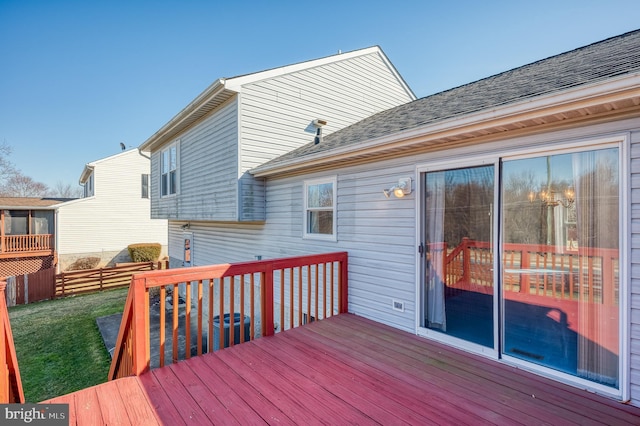 wooden deck featuring a yard and fence