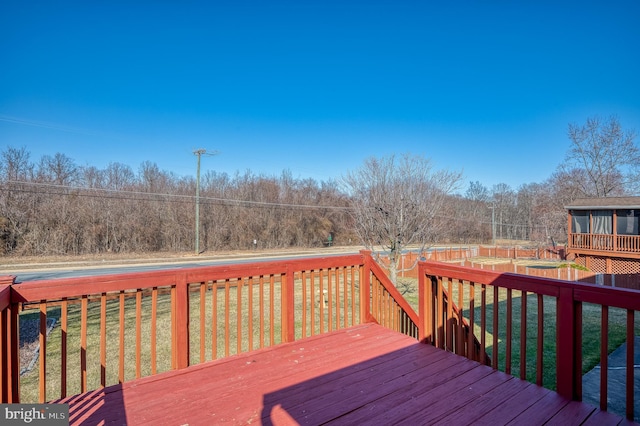 wooden terrace featuring a yard