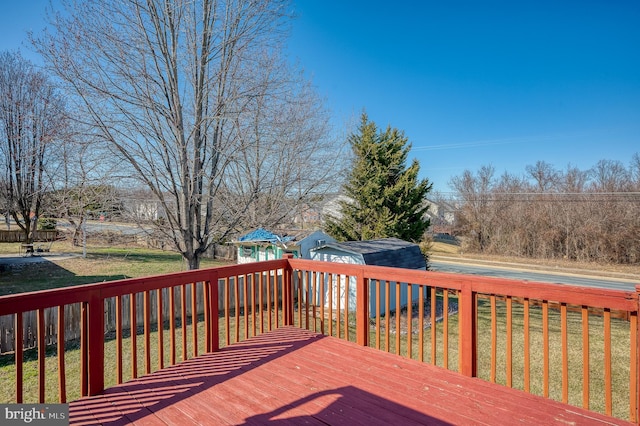 wooden deck featuring a yard