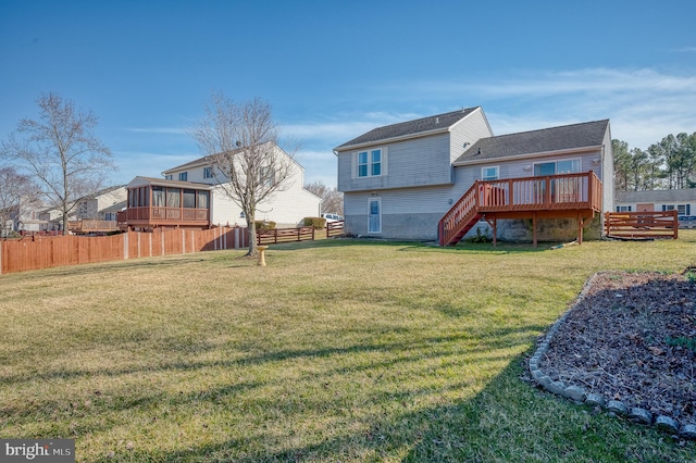 back of property with a lawn, stairs, a deck, and fence