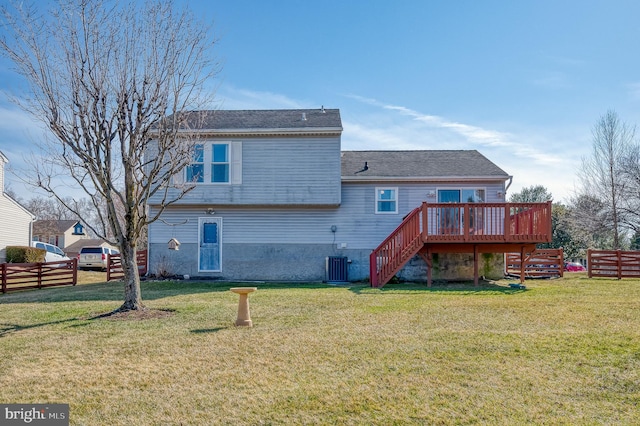 back of house featuring stairway, a lawn, and fence