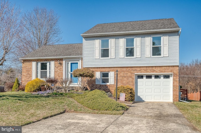 split level home with a garage, brick siding, concrete driveway, and a front yard