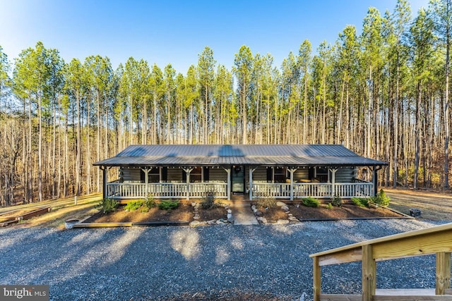 log cabin featuring covered porch