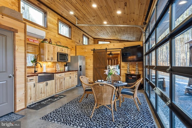 dining space with a wall unit AC, sink, wooden ceiling, and wooden walls