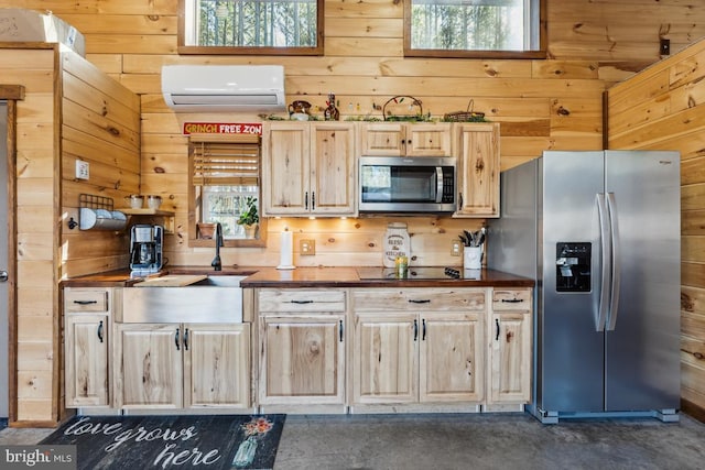 kitchen with butcher block counters, sink, wood walls, a wall mounted AC, and stainless steel appliances