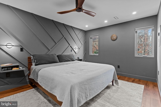 bedroom with wood-type flooring and ceiling fan