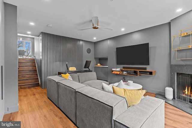 living room featuring ceiling fan and light wood-type flooring