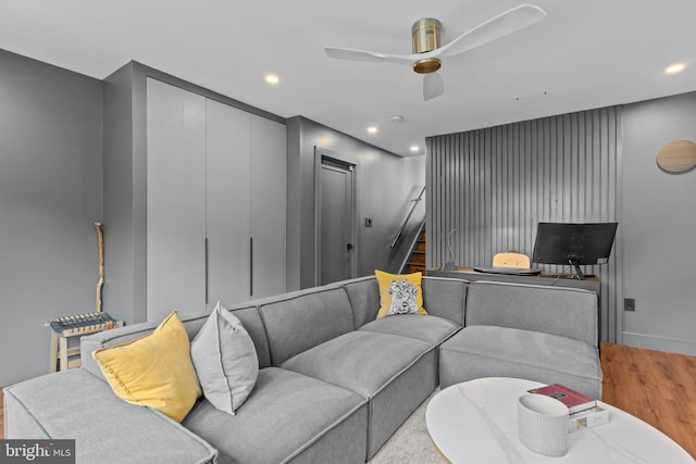 living room featuring ceiling fan and light hardwood / wood-style floors