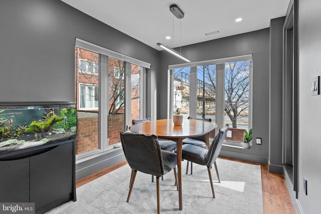 dining space with light hardwood / wood-style floors