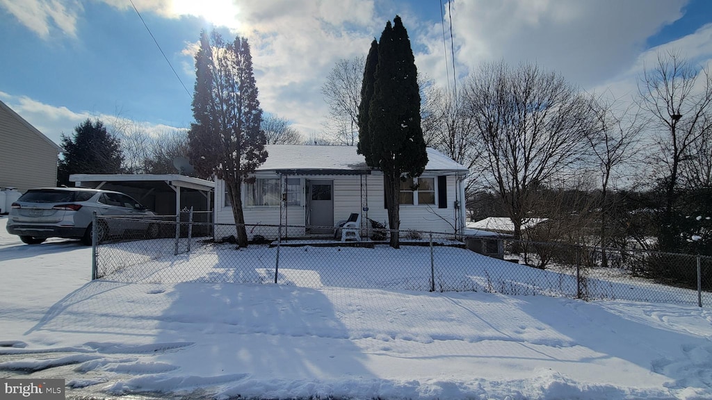 view of front facade featuring an attached carport and fence