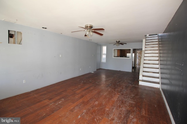 unfurnished living room with dark hardwood / wood-style floors and ceiling fan