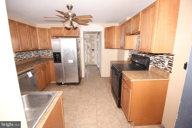 kitchen with sink, light tile patterned floors, ceiling fan, appliances with stainless steel finishes, and decorative backsplash