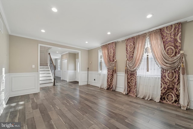 spare room featuring ornamental molding and dark hardwood / wood-style floors