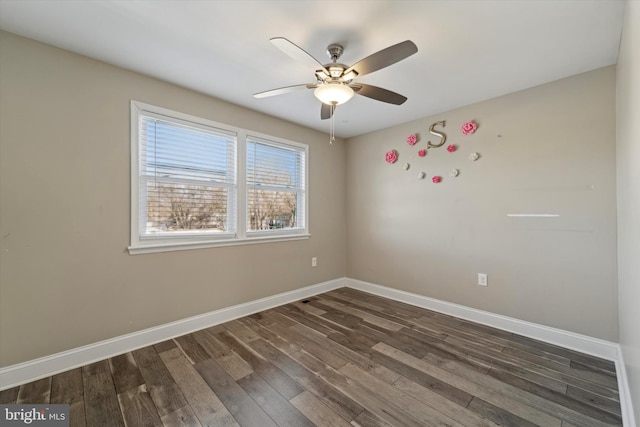 unfurnished room with ceiling fan and dark hardwood / wood-style flooring