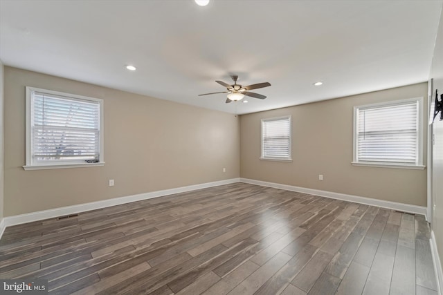 empty room featuring ceiling fan and dark hardwood / wood-style floors