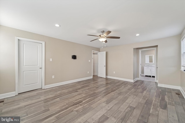 spare room with ceiling fan and wood-type flooring