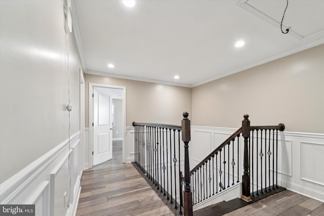 hallway featuring hardwood / wood-style flooring and ornamental molding