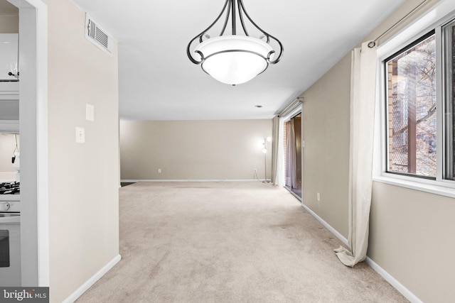 interior space with light carpet and plenty of natural light