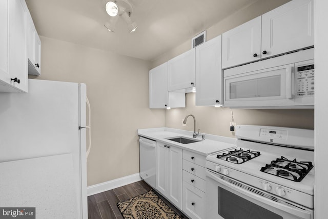 kitchen with white cabinetry, sink, and white appliances