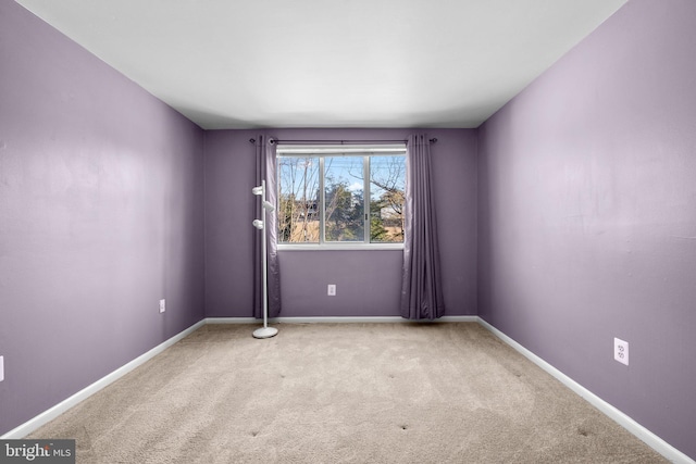 spare room featuring light colored carpet