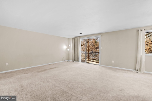 carpeted empty room with plenty of natural light