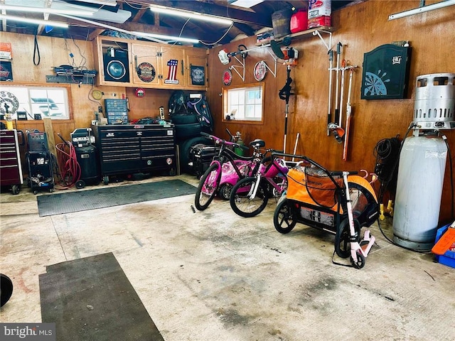 garage with wooden walls and a workshop area