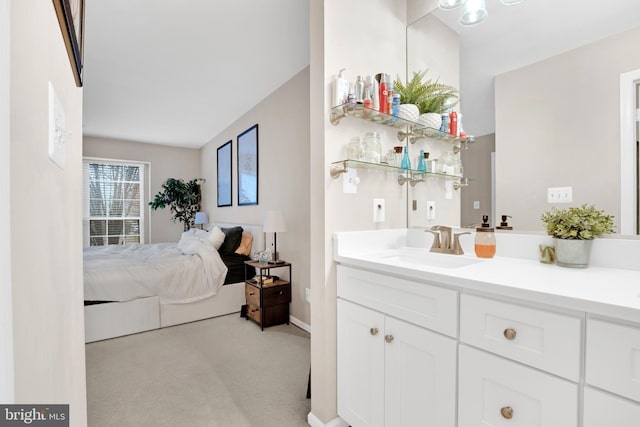 bedroom with sink and light carpet