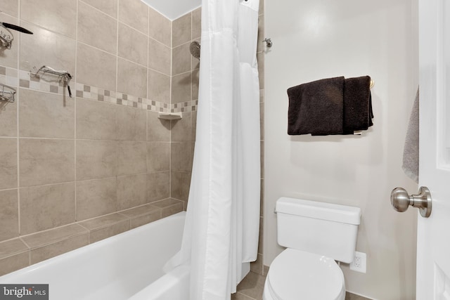 bathroom with shower / bath combo and toilet