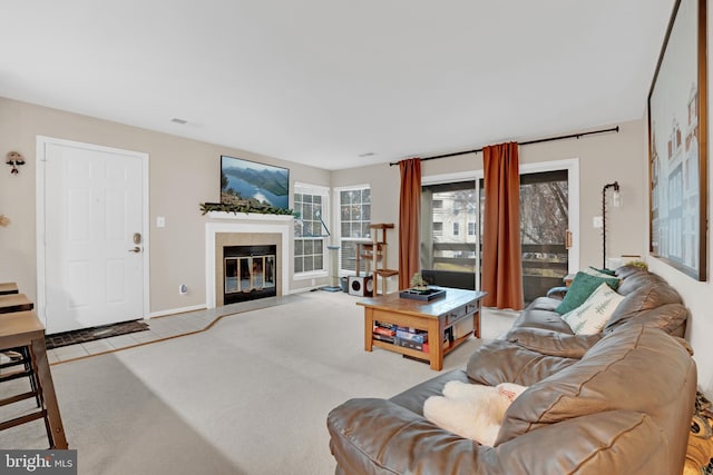 living room with a fireplace and light colored carpet