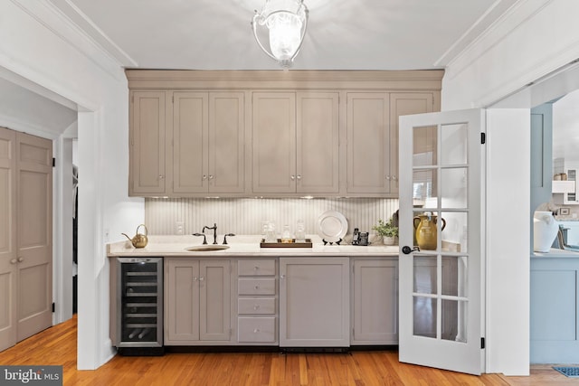 bar with gray cabinets, crown molding, sink, and wine cooler