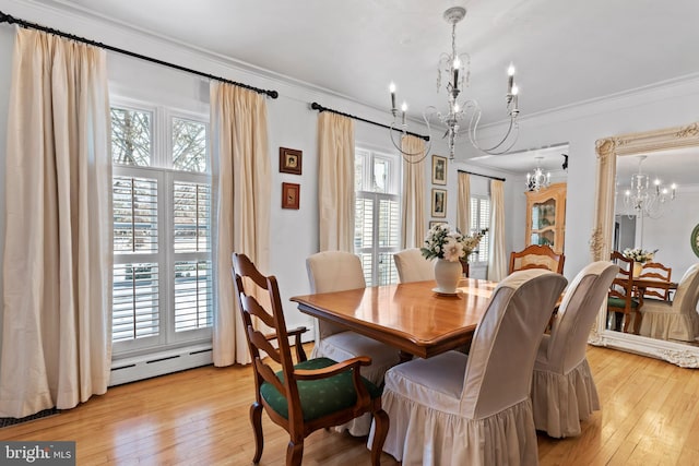 dining space featuring crown molding, a baseboard radiator, an inviting chandelier, and light hardwood / wood-style flooring