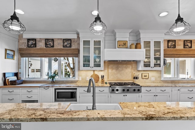 kitchen with pendant lighting, appliances with stainless steel finishes, and sink