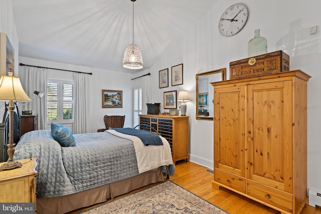 bedroom featuring a baseboard radiator and light hardwood / wood-style floors