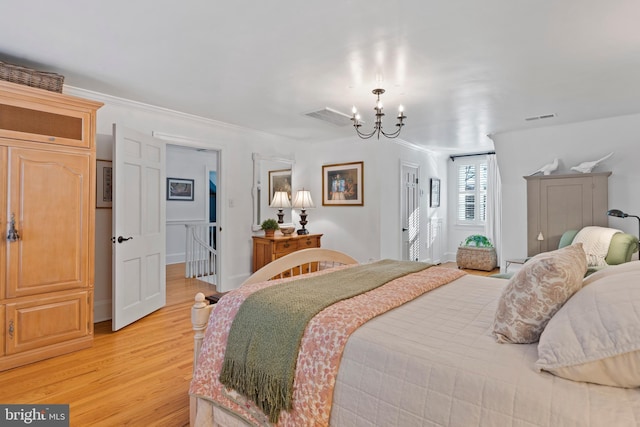 bedroom featuring a notable chandelier and light wood-type flooring