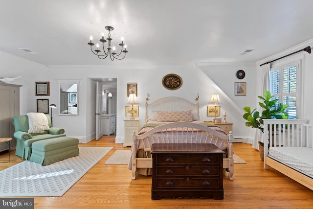 bedroom featuring crown molding, light hardwood / wood-style floors, and a notable chandelier