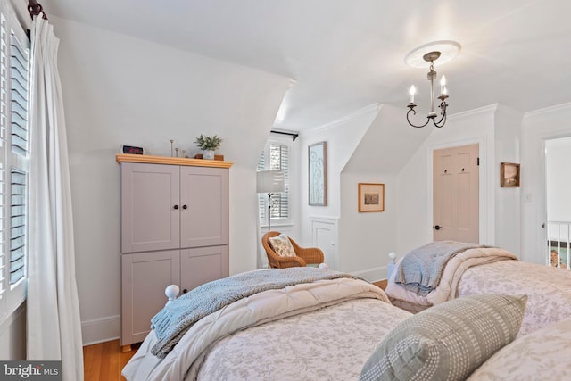 bedroom with crown molding, hardwood / wood-style flooring, and a chandelier