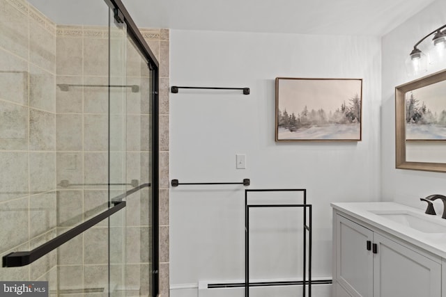 bathroom with vanity, a baseboard radiator, and a shower with door