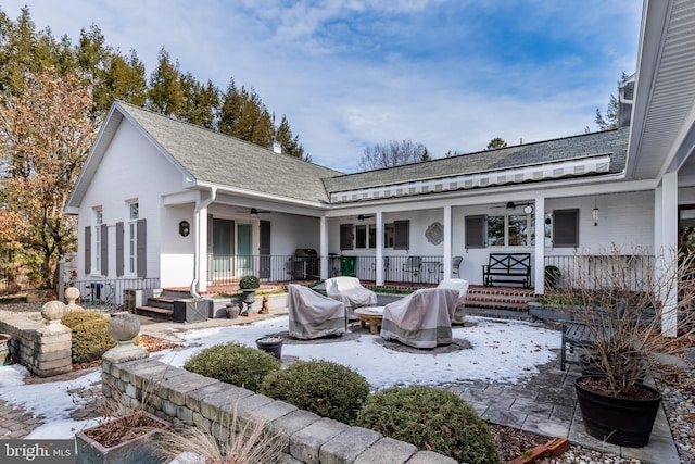 back of property featuring ceiling fan and covered porch