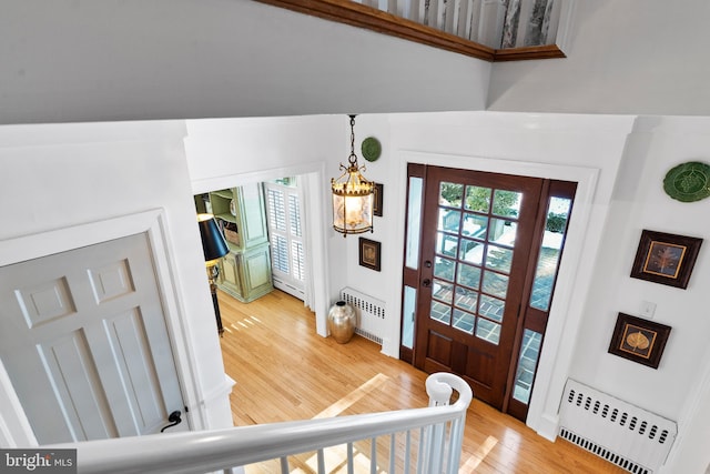 entrance foyer with radiator and hardwood / wood-style flooring