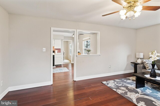 sitting room featuring ceiling fan and dark hardwood / wood-style flooring