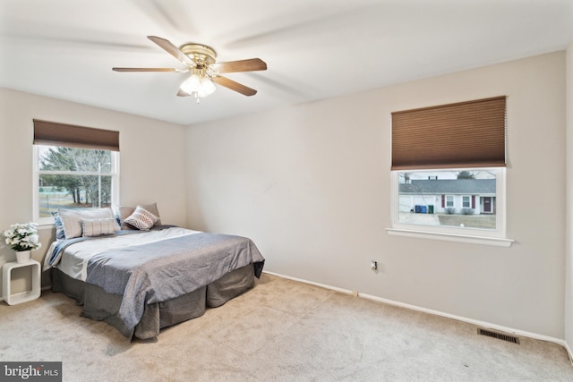 bedroom featuring light carpet and ceiling fan