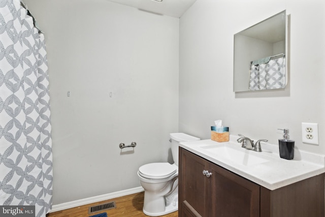 bathroom with vanity, toilet, curtained shower, and wood-type flooring