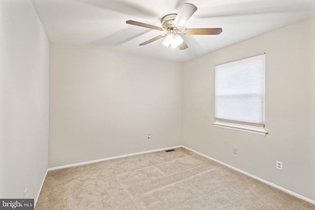 empty room featuring light carpet and ceiling fan