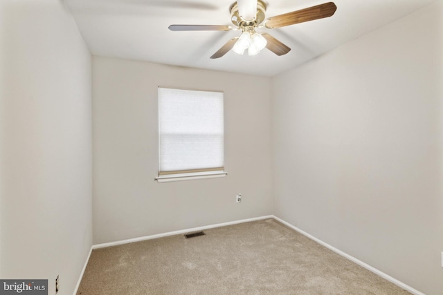 carpeted spare room with ceiling fan