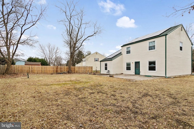 back of property featuring a yard and a patio