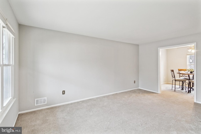 empty room with light colored carpet