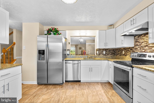 kitchen with tasteful backsplash, sink, stainless steel appliances, and white cabinets